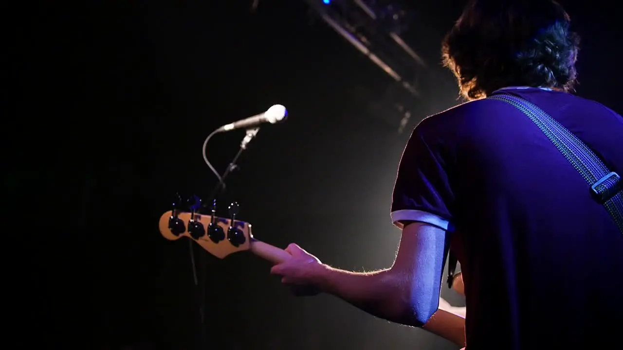 Man playing guitar on a concert stage