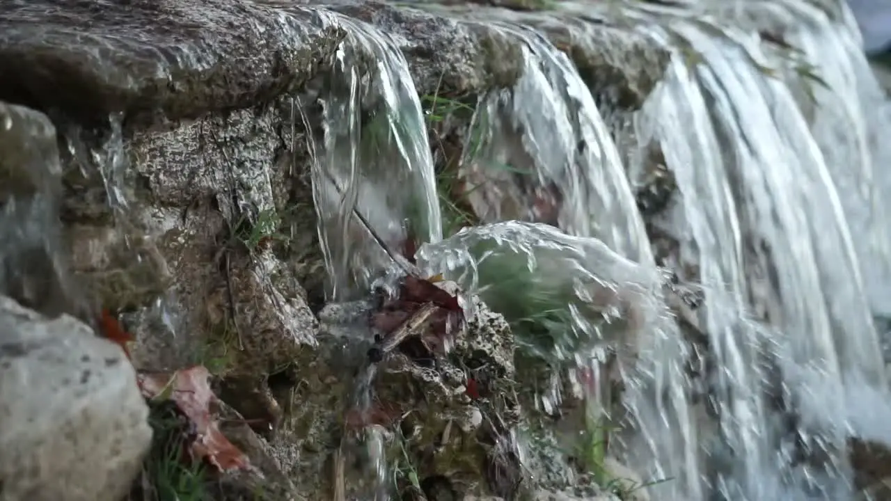 Panning close up shot of small waterfall slow motion