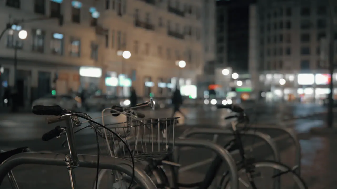 Parked bicycles against night blurred city