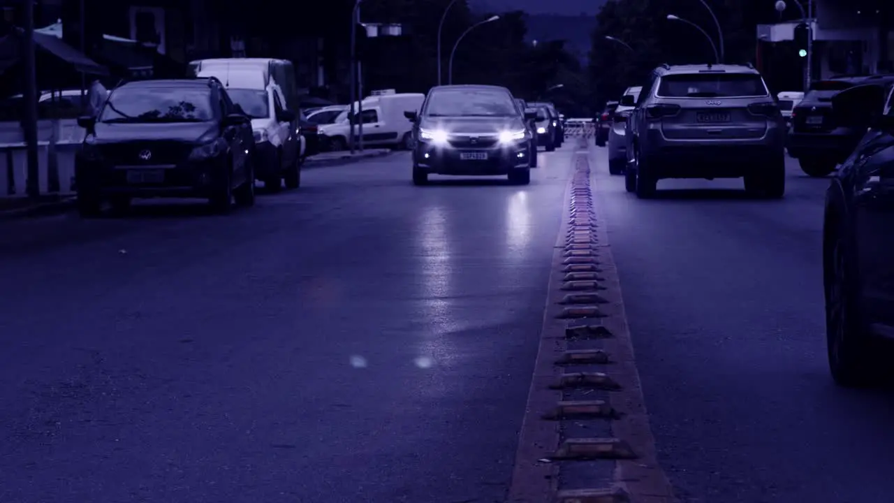 Cars driving on road in Brazil in slow motion mysterious blue tint filter