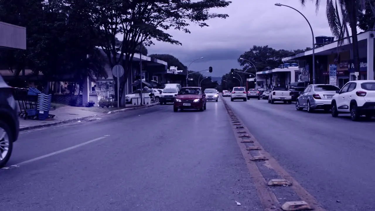 Cars driving on a main road in Brazil on gloomy overcast day desaturated filter effect