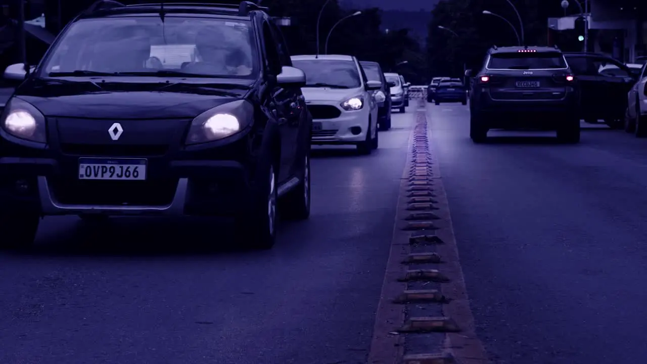 Traffic driving on road in slow motion in Brazil blue tint filter effect