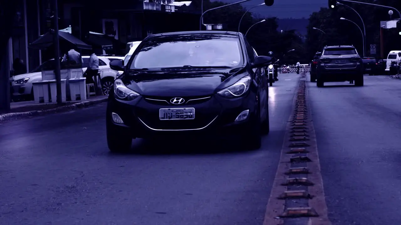 Traffic driving on main road in Brazil in slow mo desaturated gloomy filter effect