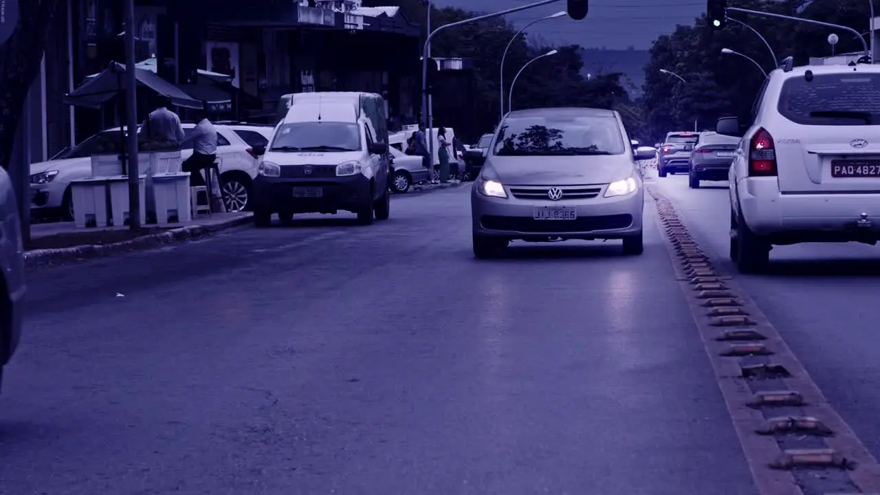 Cars driving on road in super slow motion in Brazil gloomy filter effect