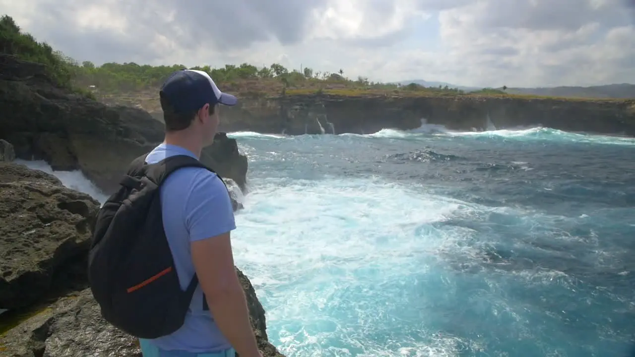 Tourist Overlooking Rough Ocean