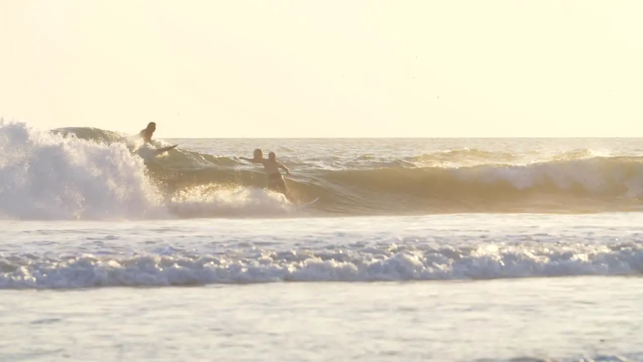 Slow Motion Shot of Surfers in the Ocean