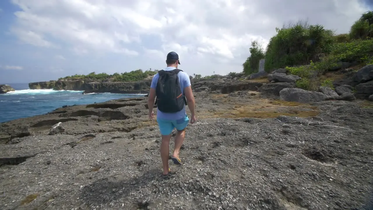 Tourist Walking Along Bali Coastline