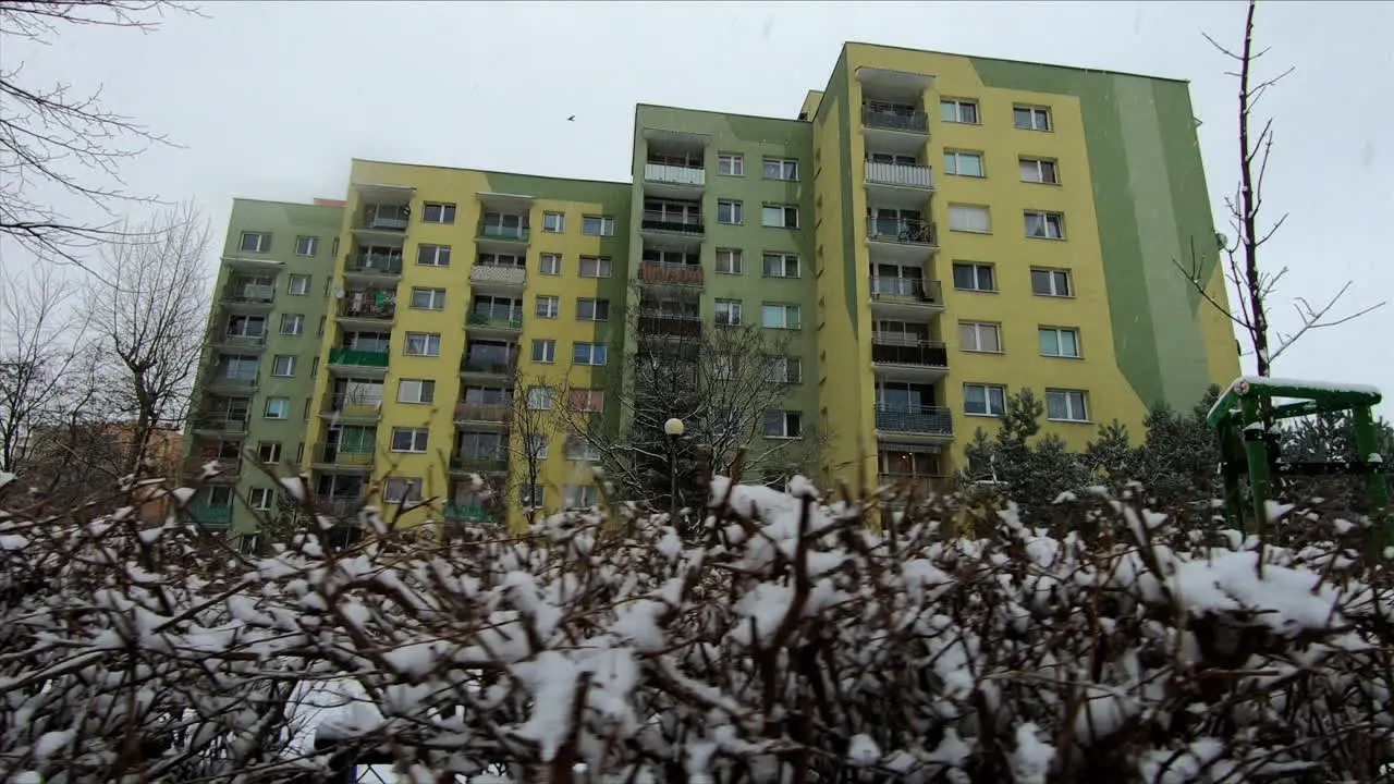 Snow is falling in a city suburb during winter