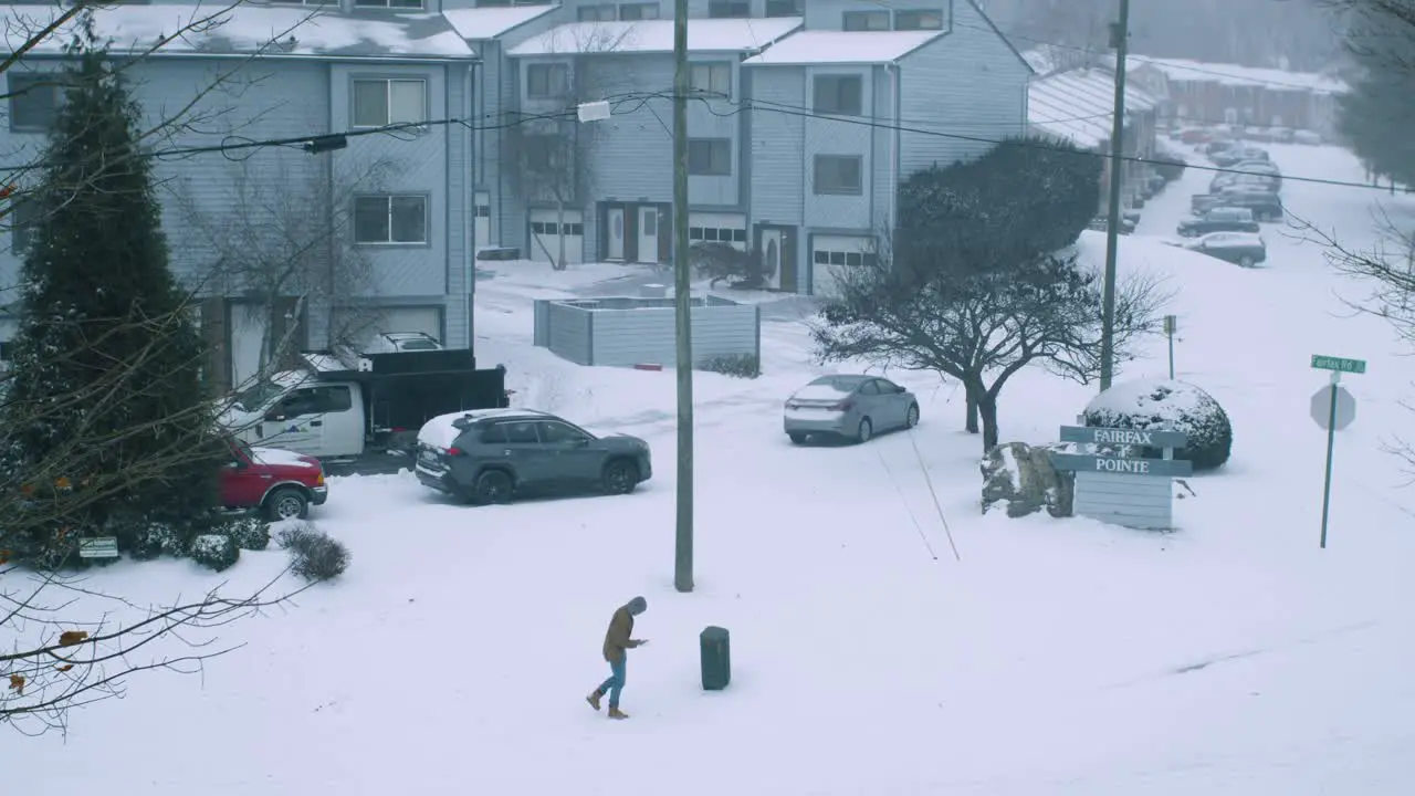 Man walking during windy snow storm