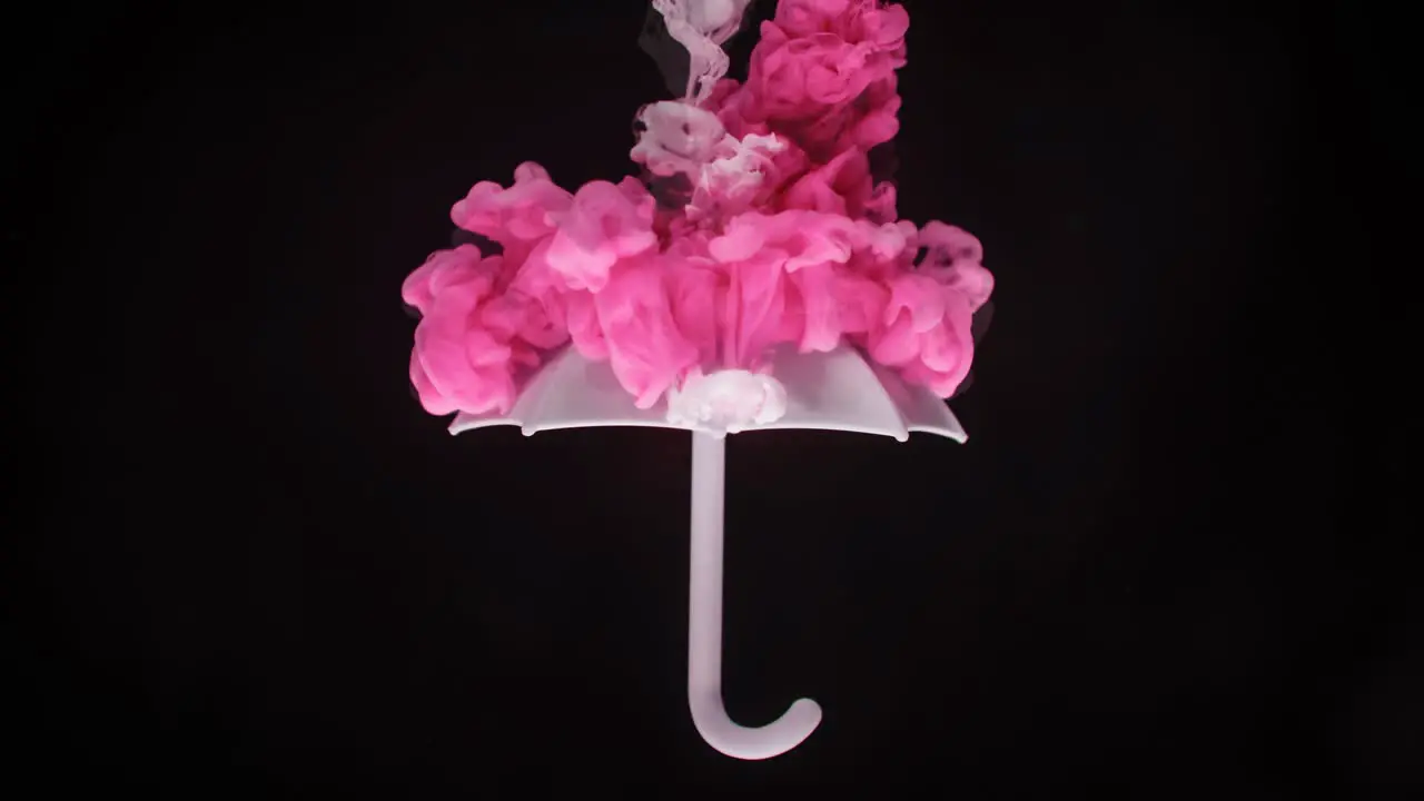 Cinemagraph Floating umbrella with pink ribbon