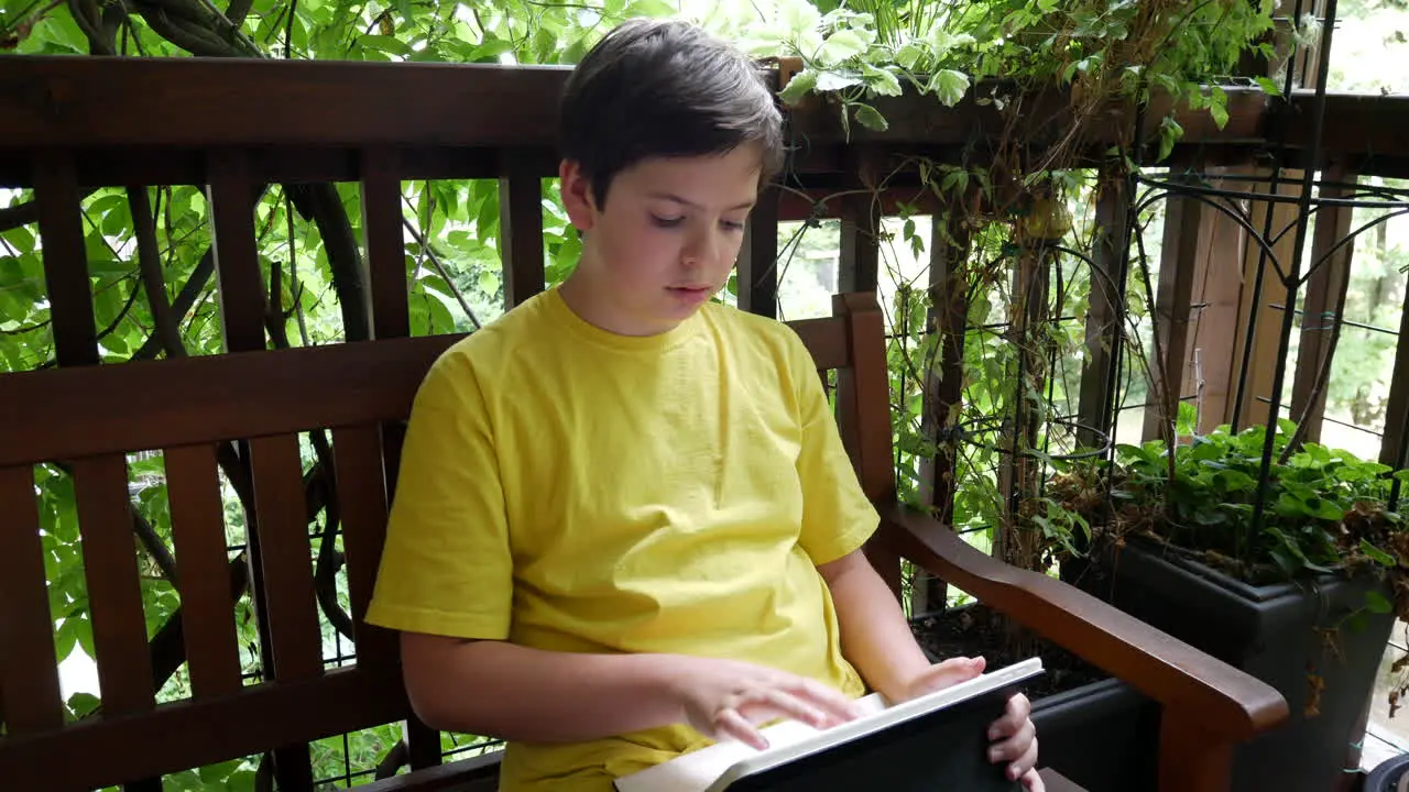 Boy doing homework on the balcony