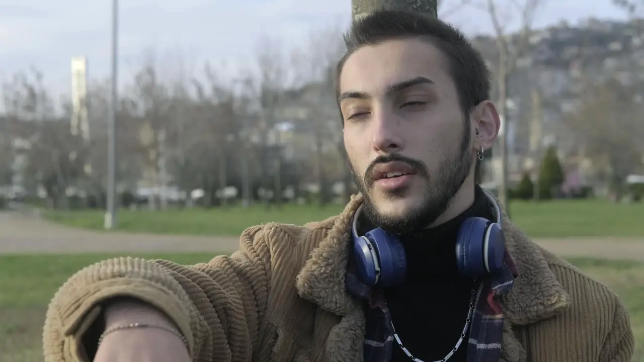 Young Man Waiting Friends At Park