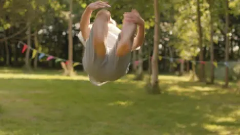 Medium Shot of Athletic Young Boy Doing Backflip