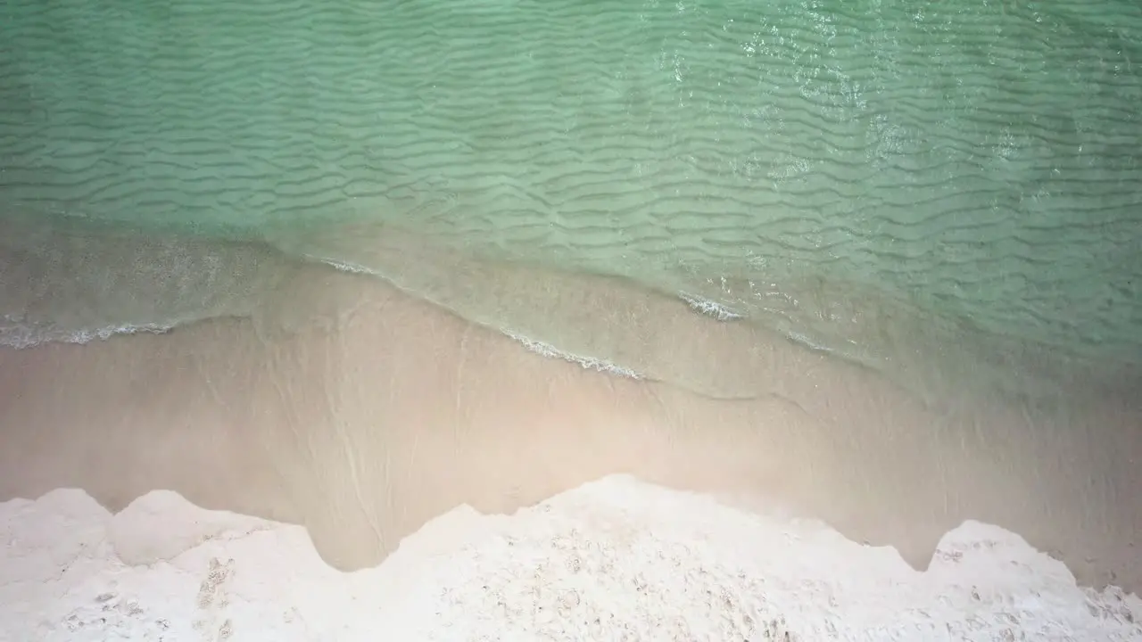 Clearwater waves of emerald waters on white sand beach on the Gulf of Mexico Aerial view