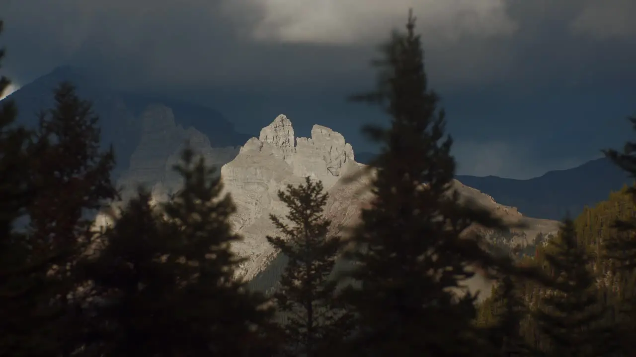 Mountain top in sunshine from forest on cloudy day