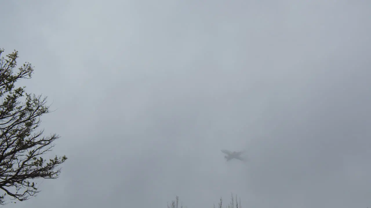 Airplane vanishing in overcast sky