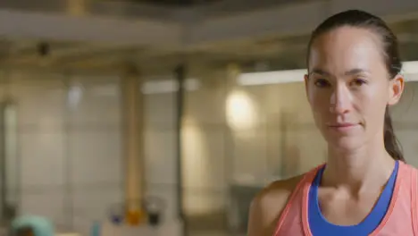 Mid Shot of a Young Woman Looking at Camera in Gym