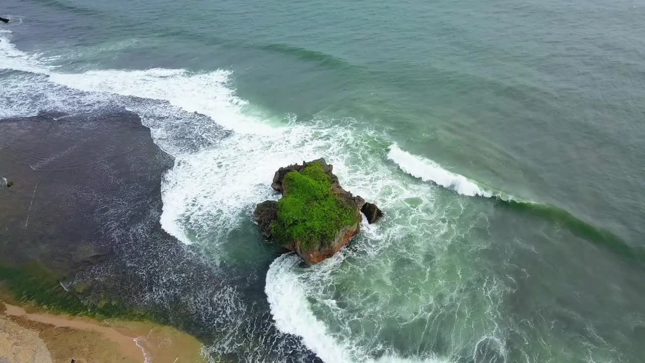 Waves crashing over coral rock reef on the south coast of Java Island Indonesia