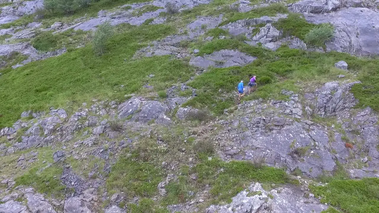 Couple climbing a mountain aerial shot