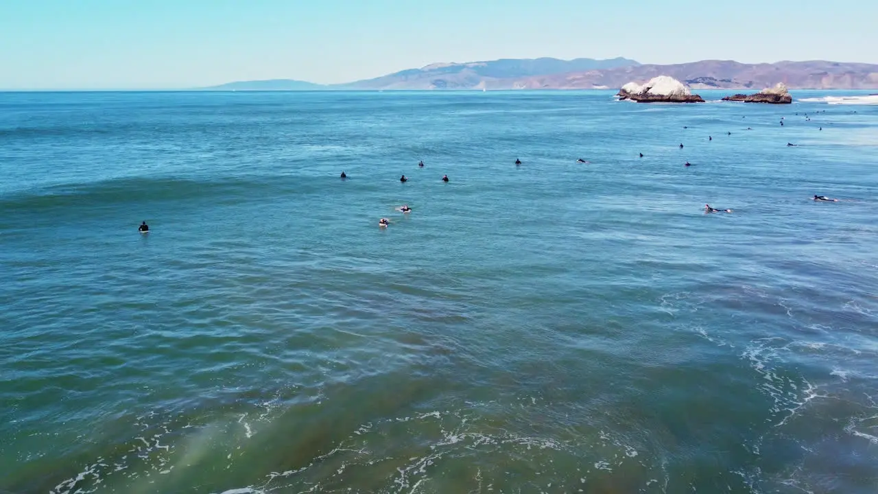 Surfers Surfing At Ocean Beach Coast With Seal Rocks In The Distance In San Francisco California