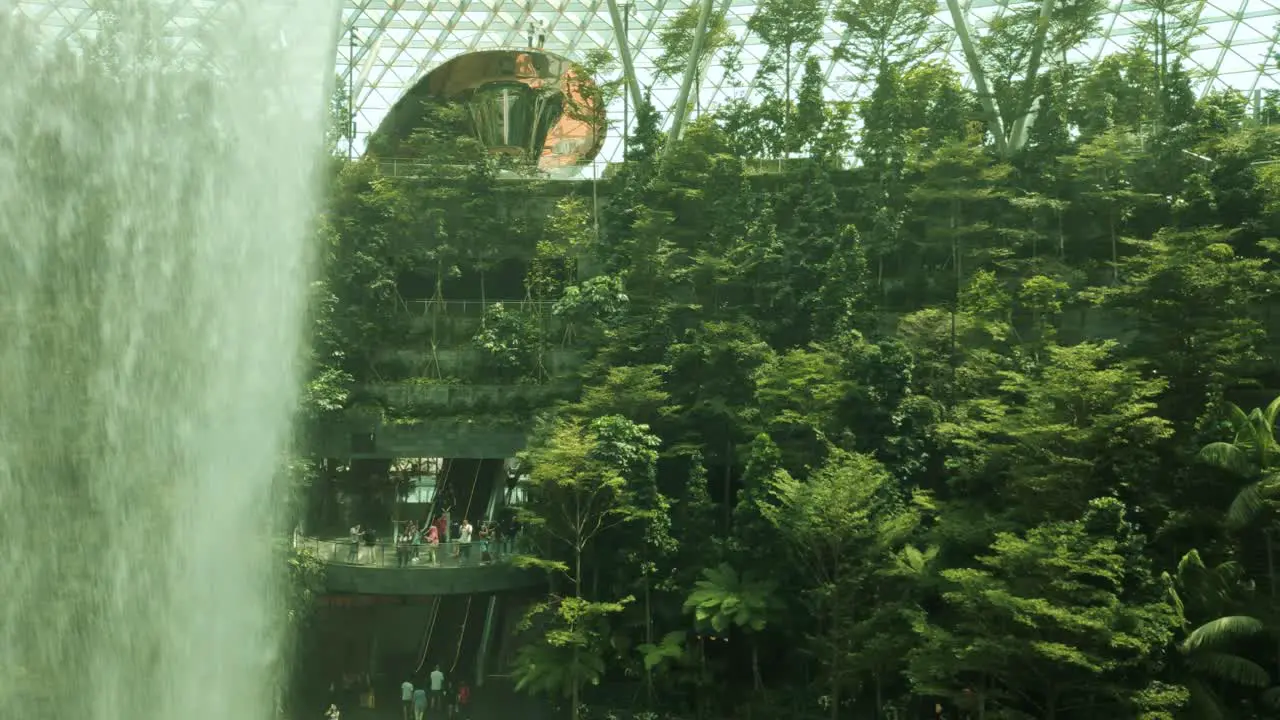 Slow-motion aerial Singapore Changi Jewel Rain Vortex waterfall