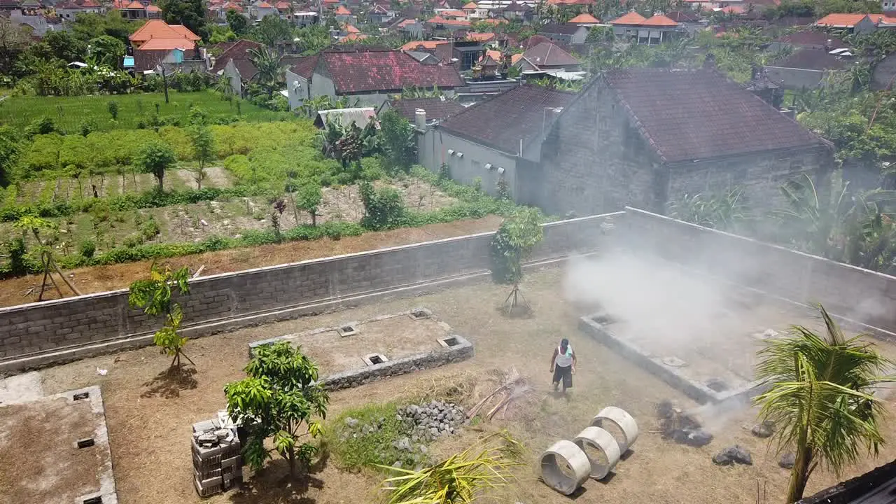 Farmer Burning Wood in Bali Indonesia Creating Toxic Smoke near Rice Fields