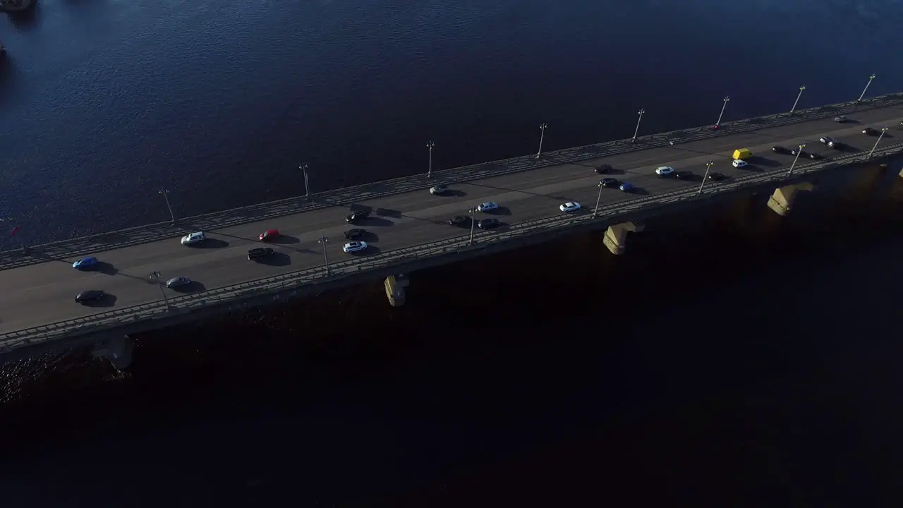 Car motion on highway bridge over river Drone view car driving on river bridge