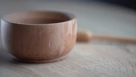 wooden bowl Close-up Healthy organic wooden honey spoon closeup