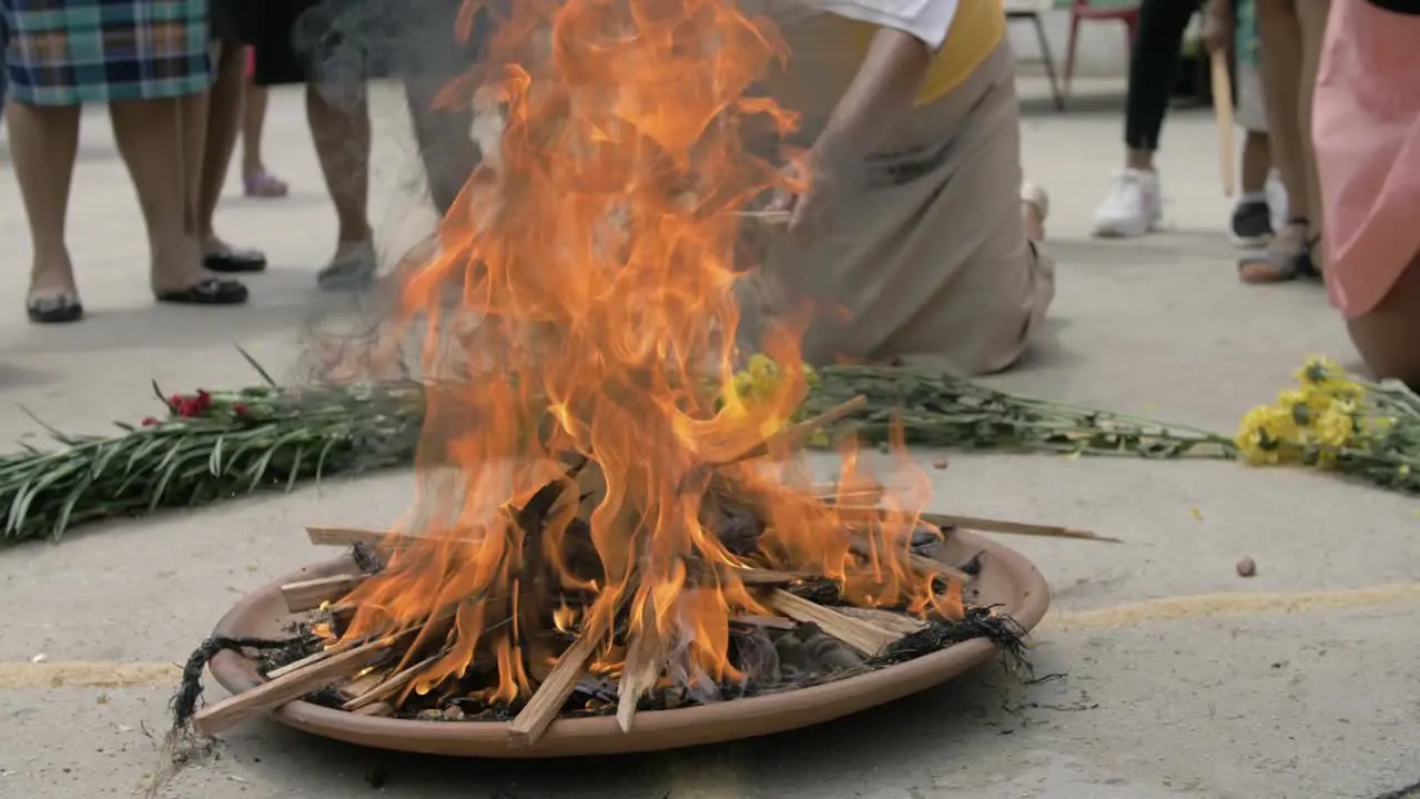 Mayan religious ritual performed with sacred fire offering surrounded by flowers and other elements Slow Motion