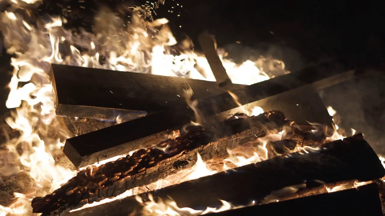 4K Video of wood being added to a Bonfire