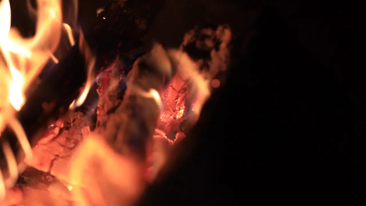 Close up shot of logs burning in a fire pit