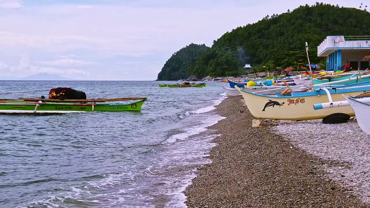 Slow motion clip of a tropical beach with raw boats in the Surigao Mindanao Philippines