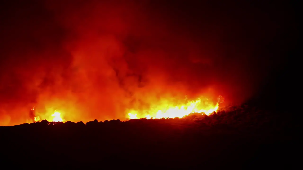 Shot of white smoke coming out of fire burning on a dark night