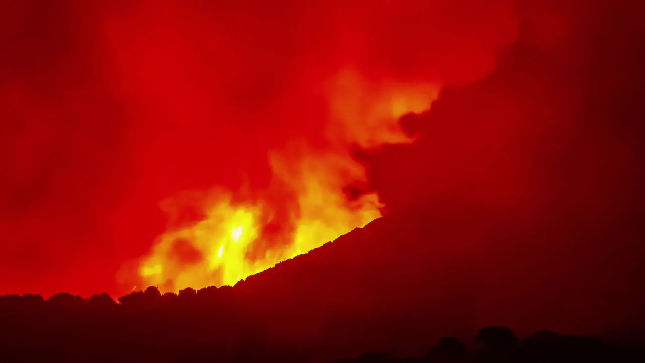 big forest fire time-lapse at night burning in big flames on mountain landscape