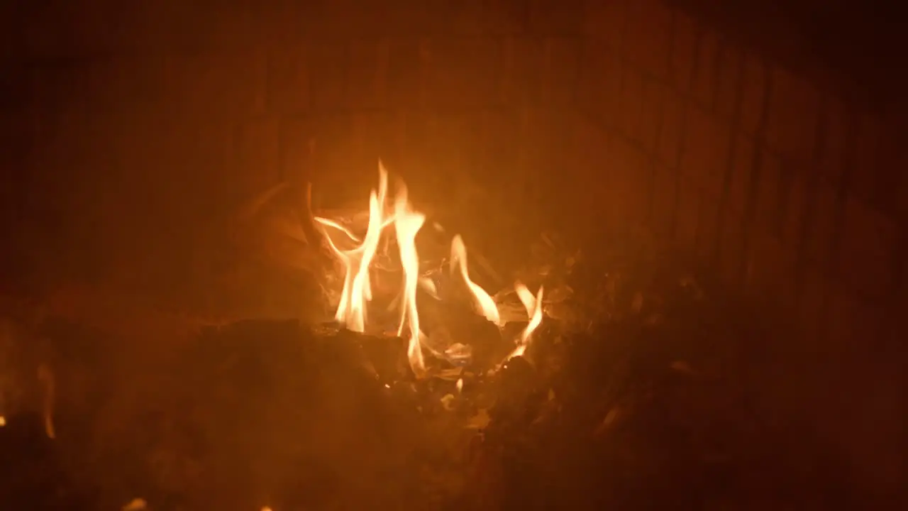 Slow motion footage of fire burning trash in a fire pit