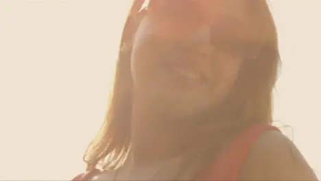 Close Up Shot of Young Festival Goer Backlit Against the Sun