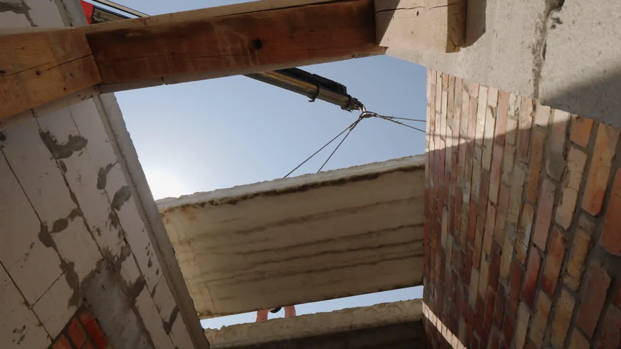 A Crane Installs A Floor Panel In A Multi-Storey Building A Bottom View