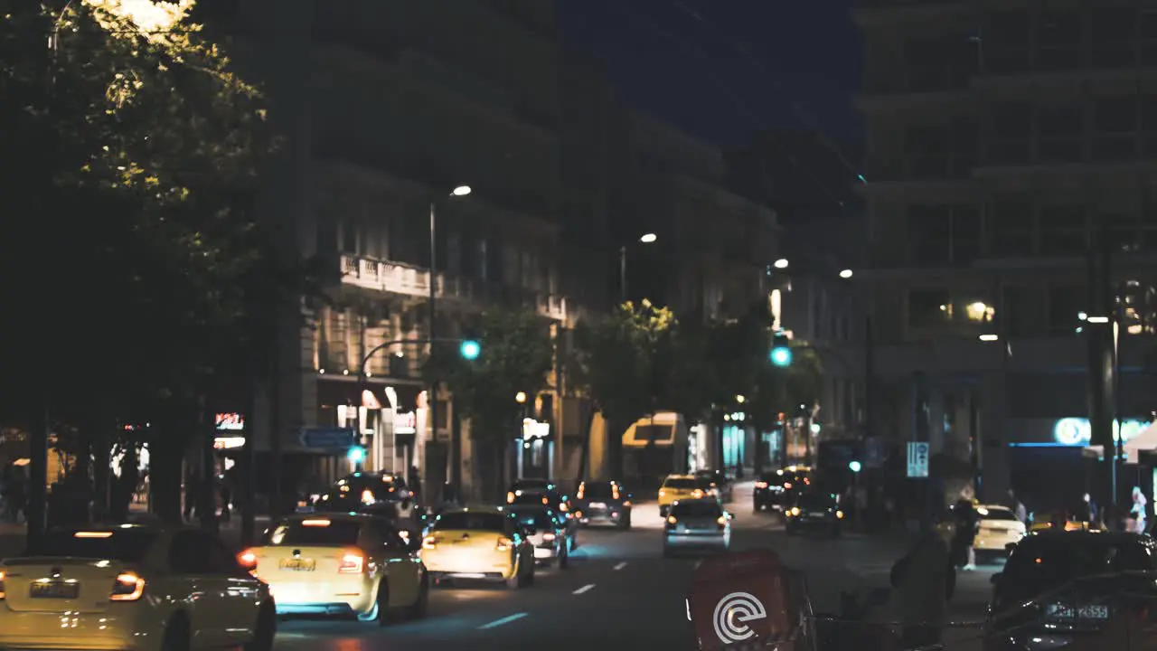 Cars driving by Syntagma Square at night