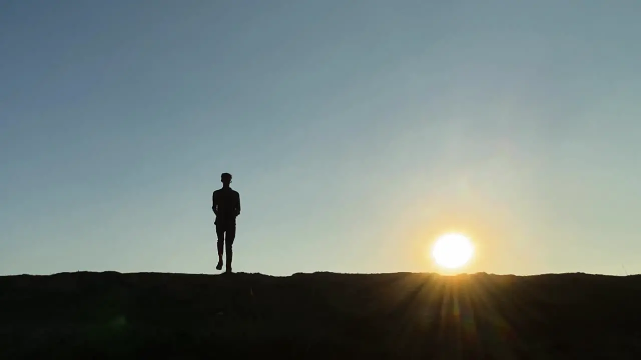 Skinny young man exercising jogging in place at sunrise