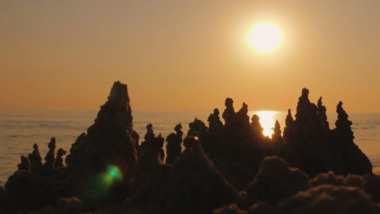 Silhouette Of A Sand Castle Against The Background Of The Setting Sun And Sea Waves 4K Video