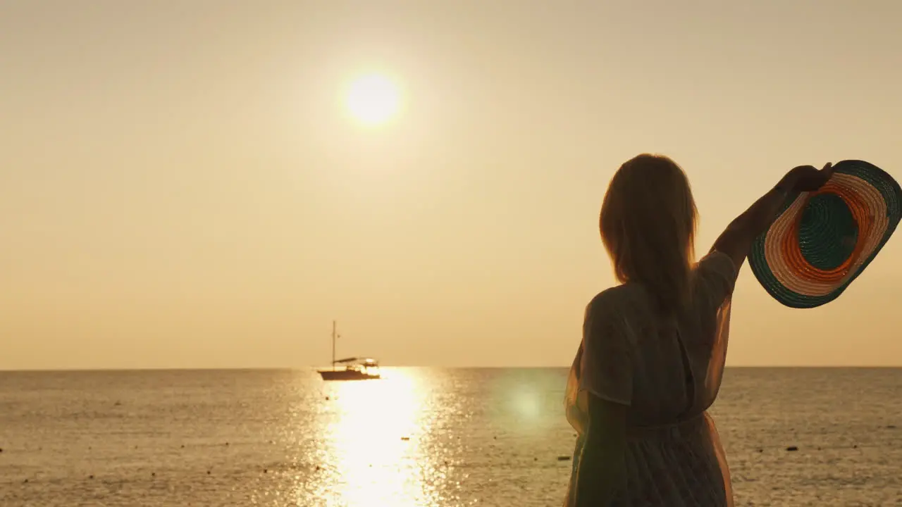 A Woman Waves Her Hat To A Distant Ship Standing On The Pier In The Early Morning Meets The Dawn 4k 