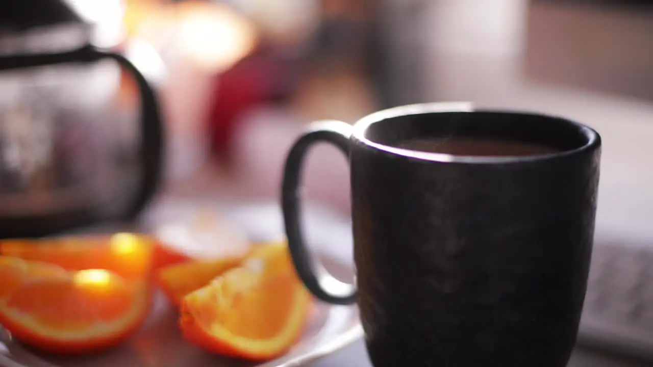 Cozy background of a cup of tangerine or mandarin tea selective focus backdrop with copy space relaxing concept