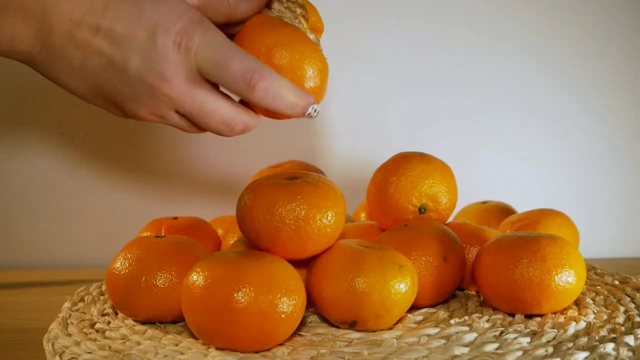 Hands peeling citrus fruit