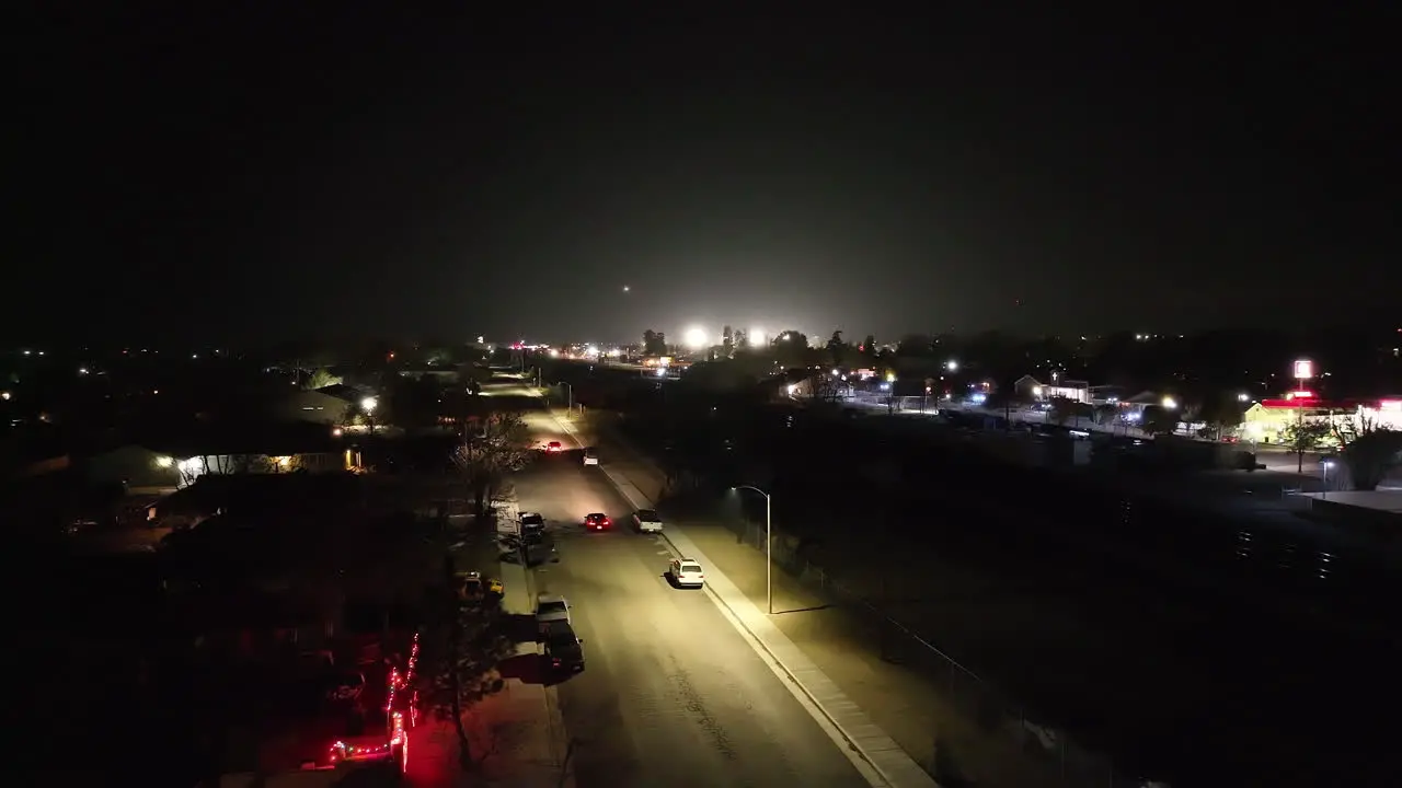 Nighttime street traffic in Tehachapi City California static drone view