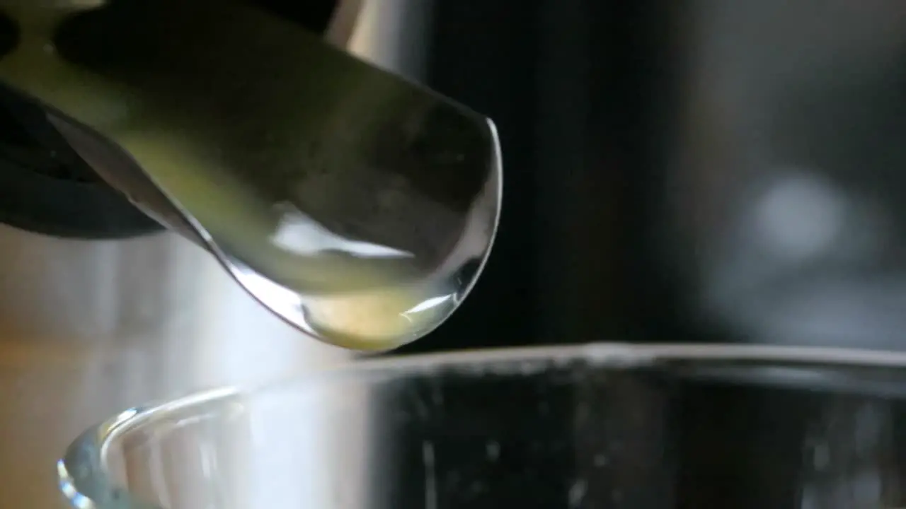 Orange juice pouring into glass when it has directly been squeeze from the orange