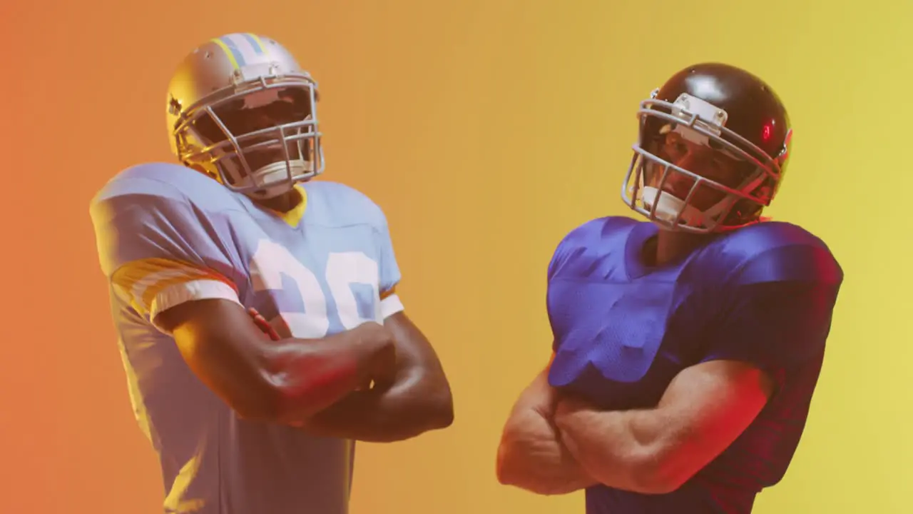 Video of diverse american football players over yellow to orange background