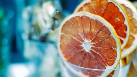 Red grapefruit slices in glass prepared for use in cocktails