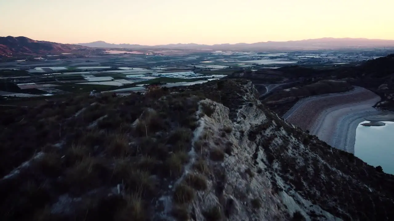 Sunset over the mountain range in the region of Murcia and its water reservoir Spain