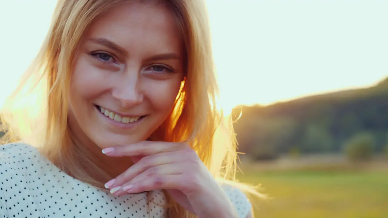 Portrait Of A Beautiful Young Woman At Sunset Orange Light Highlights Her Hair Behind