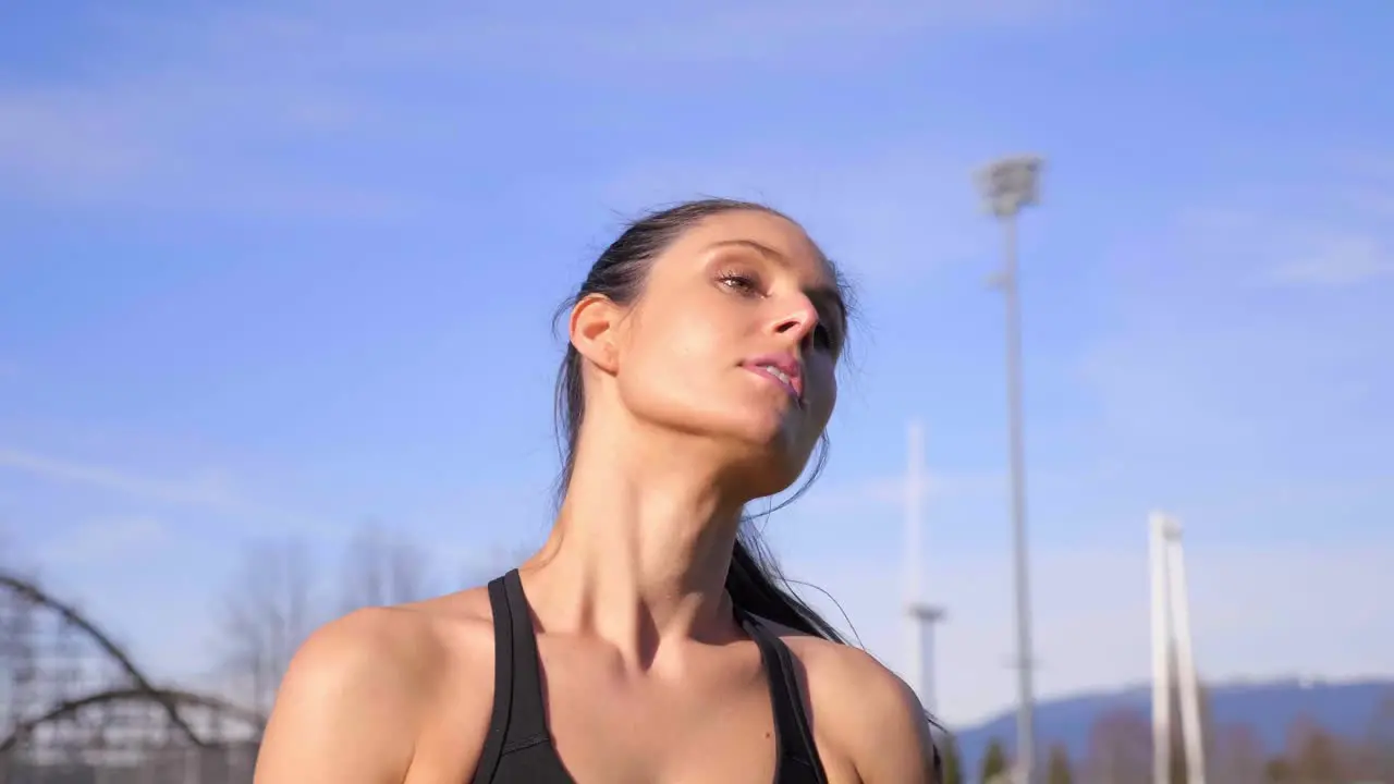 Attractive athletic woman tying hair up before beginning run